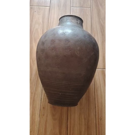 Dark Brown‑Glazed Pottery Jar with Bow‑String Patterns